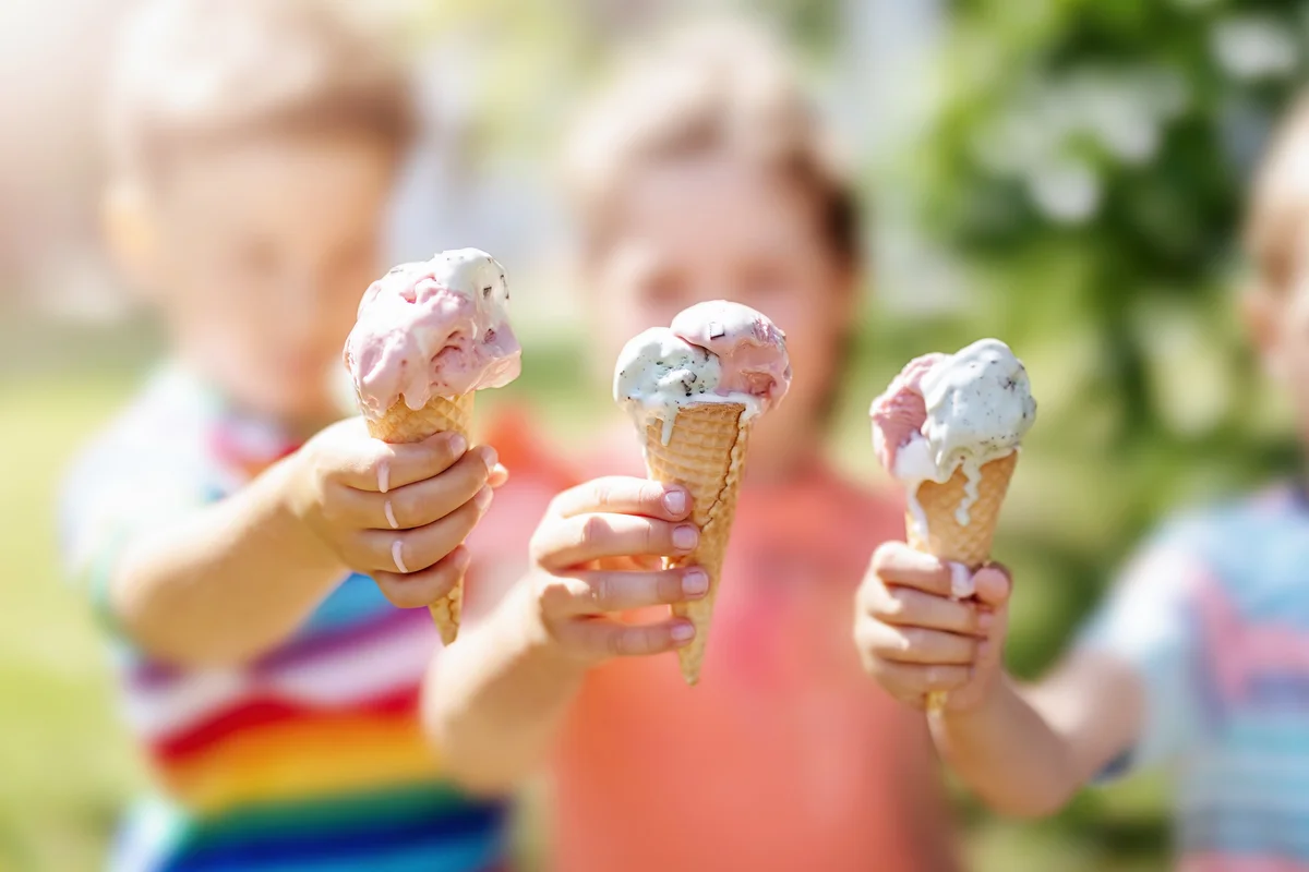 Group of children in the park eating ice cream