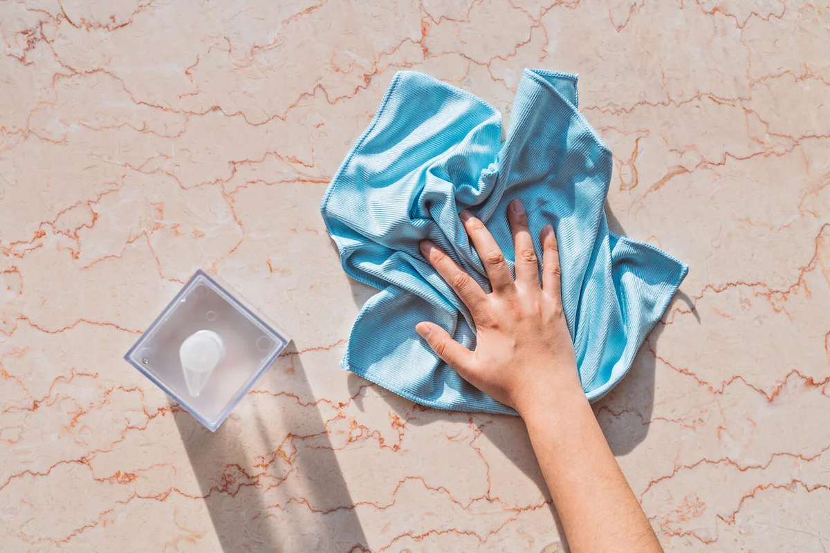 Woman Hand Cleaning Marble Surface