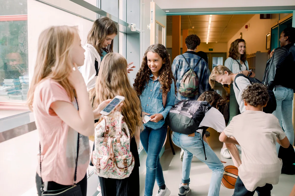Middle and junior high students in school corridor during lunch break