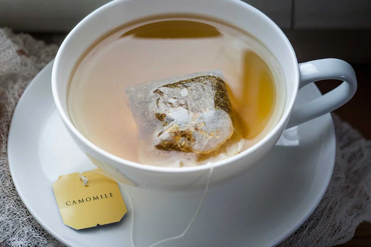 Chamomile tea bag steeping in cup