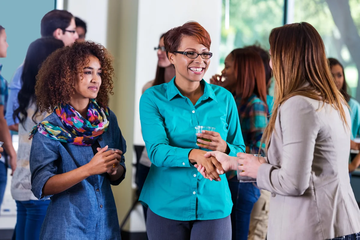 Woman meeting daughter's professor during open house