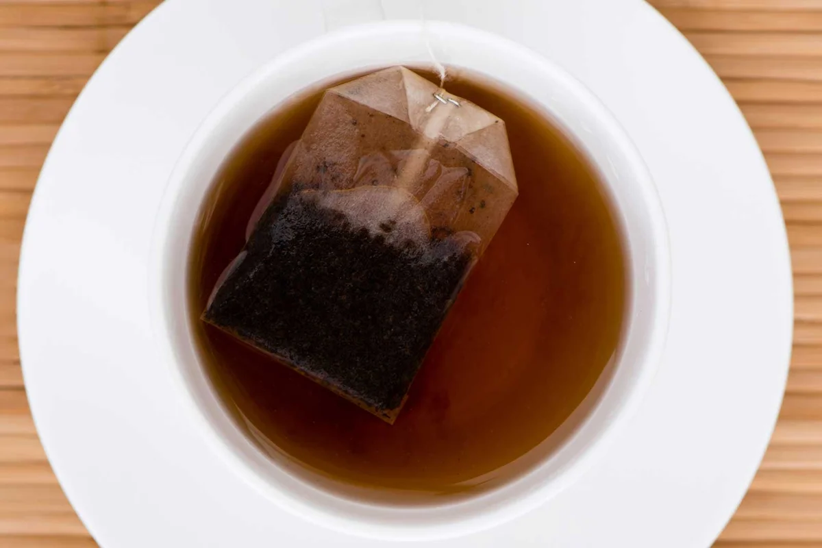 black tea steeping in cup for anti anxiety and calm wellness