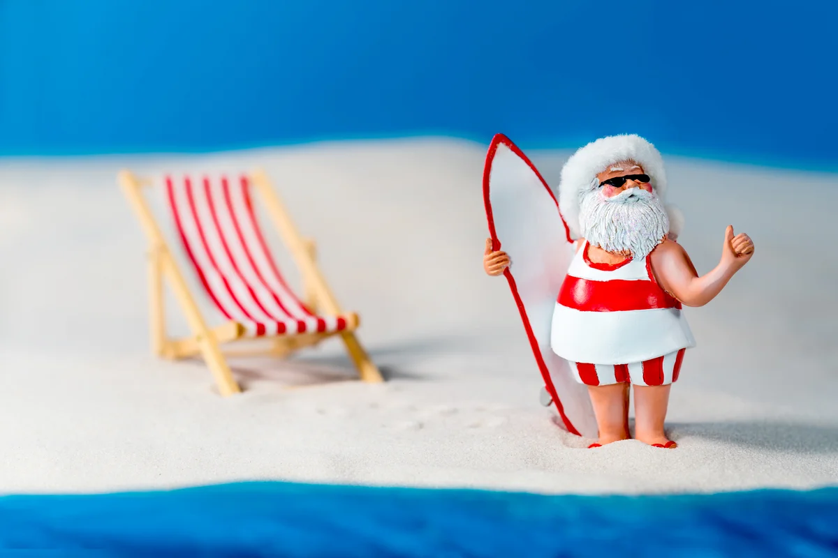 Santa Claus Takes A Surfing Holiday At The Beach
