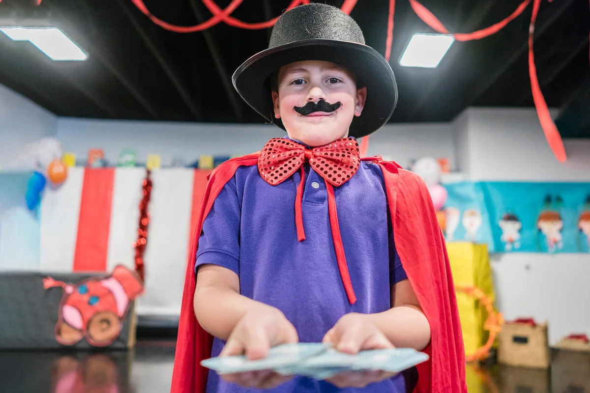 Magician boy performing in theater circus