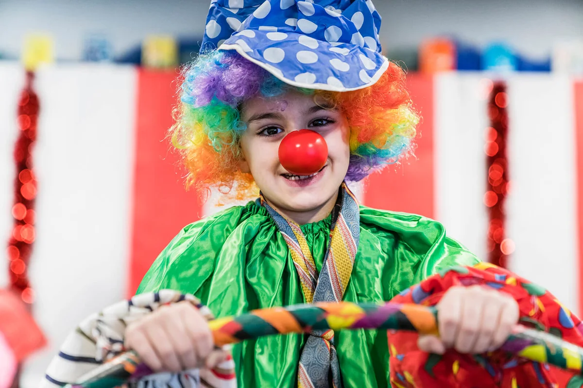 Portrait of boy wearing clown costume