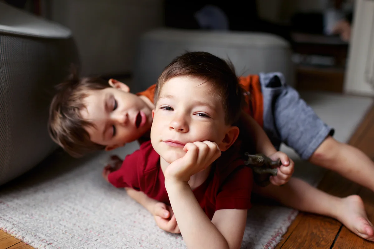 Two brothers playing together at home