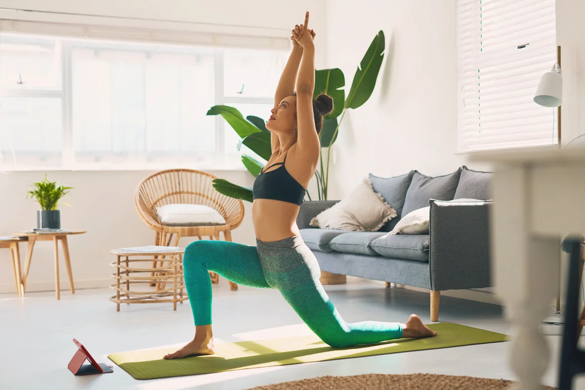 Young woman practicing yoga at home
