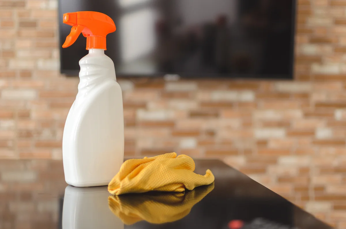 DIY degreaser in spray bottle on counter with cloth