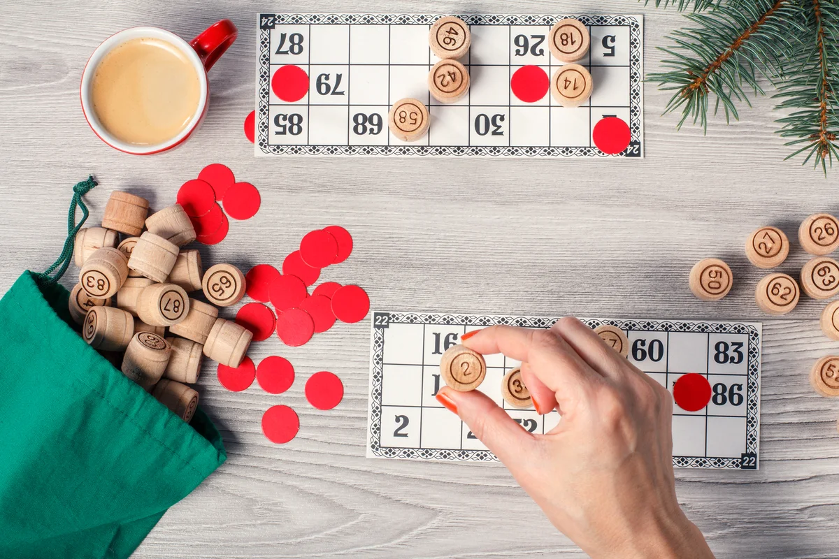 Woman's hand holding a wooden barrel for a game in lotto