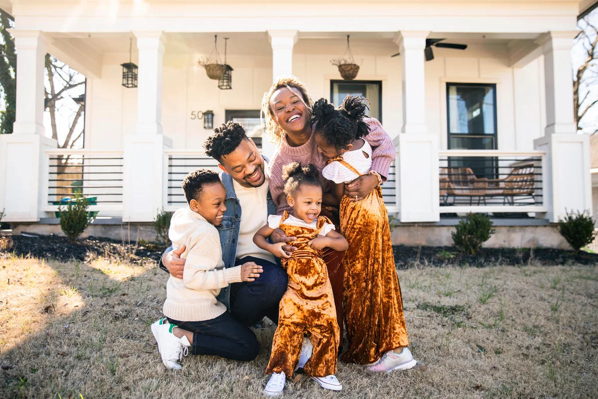 Beautiful family in front of home