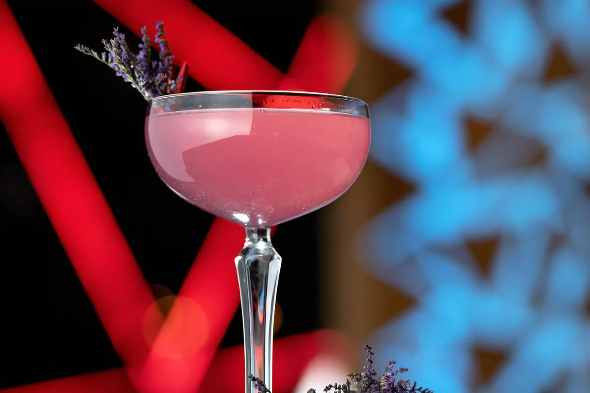 Glass with pink drink with lavender flowers