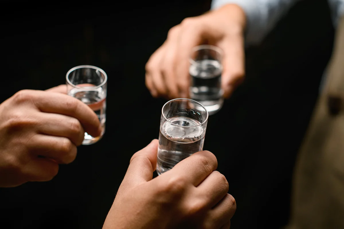 Hands cheering with Bacardi shots