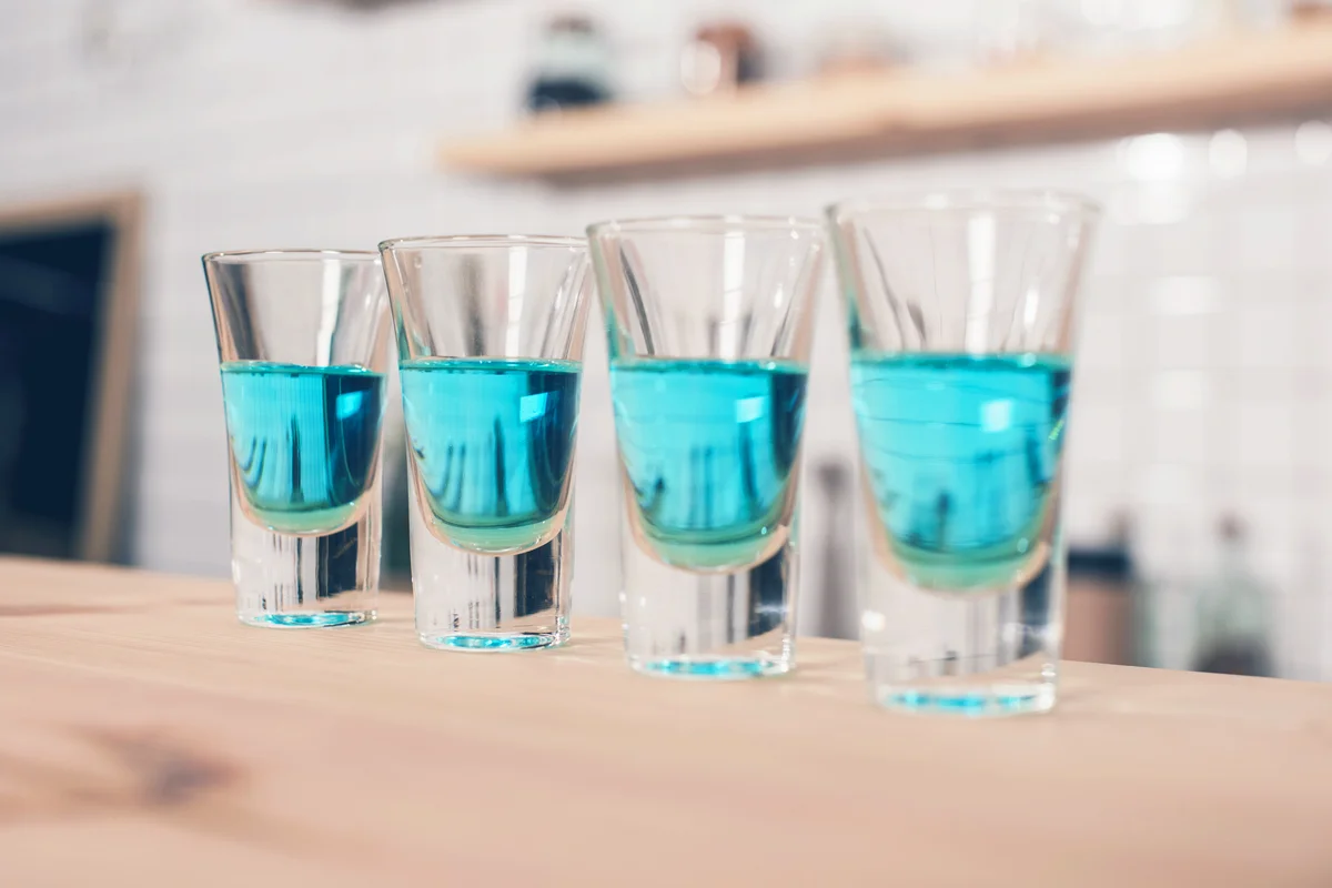 Blue cocktails in shot glasses