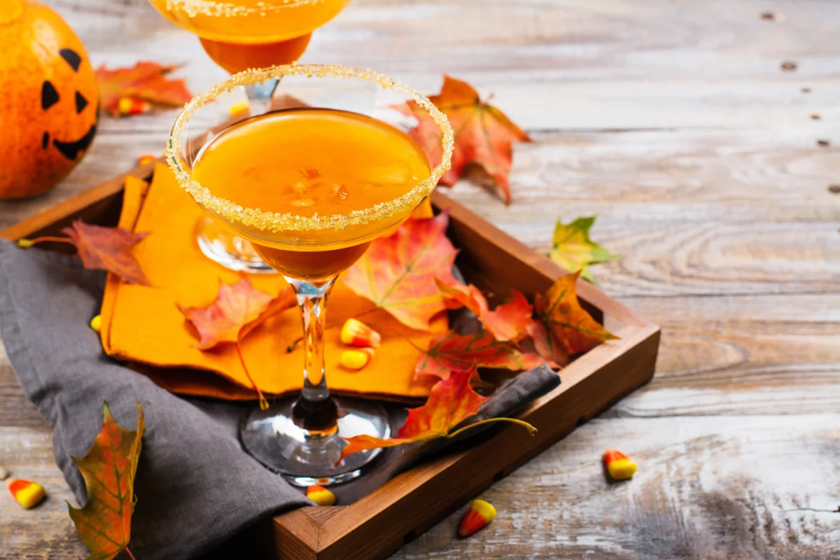 Autumn pumpkin martini cocktail with candy corn