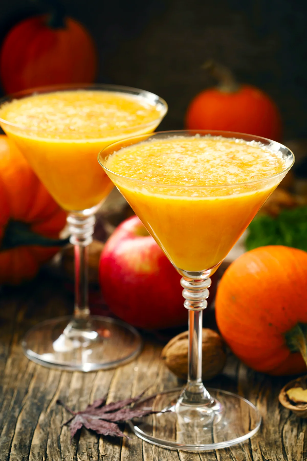 Pumpkin martini and pumpkins in a fall setting