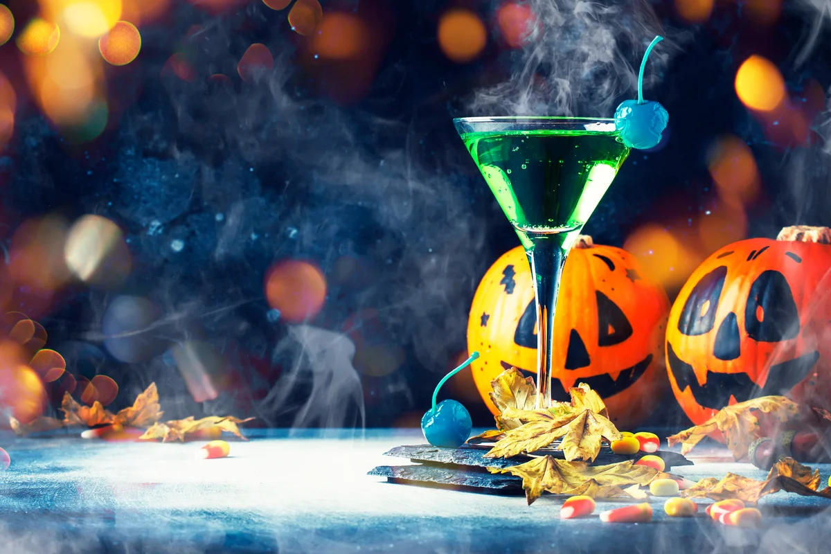 Halloween festive green drink and pumpkins lanterns