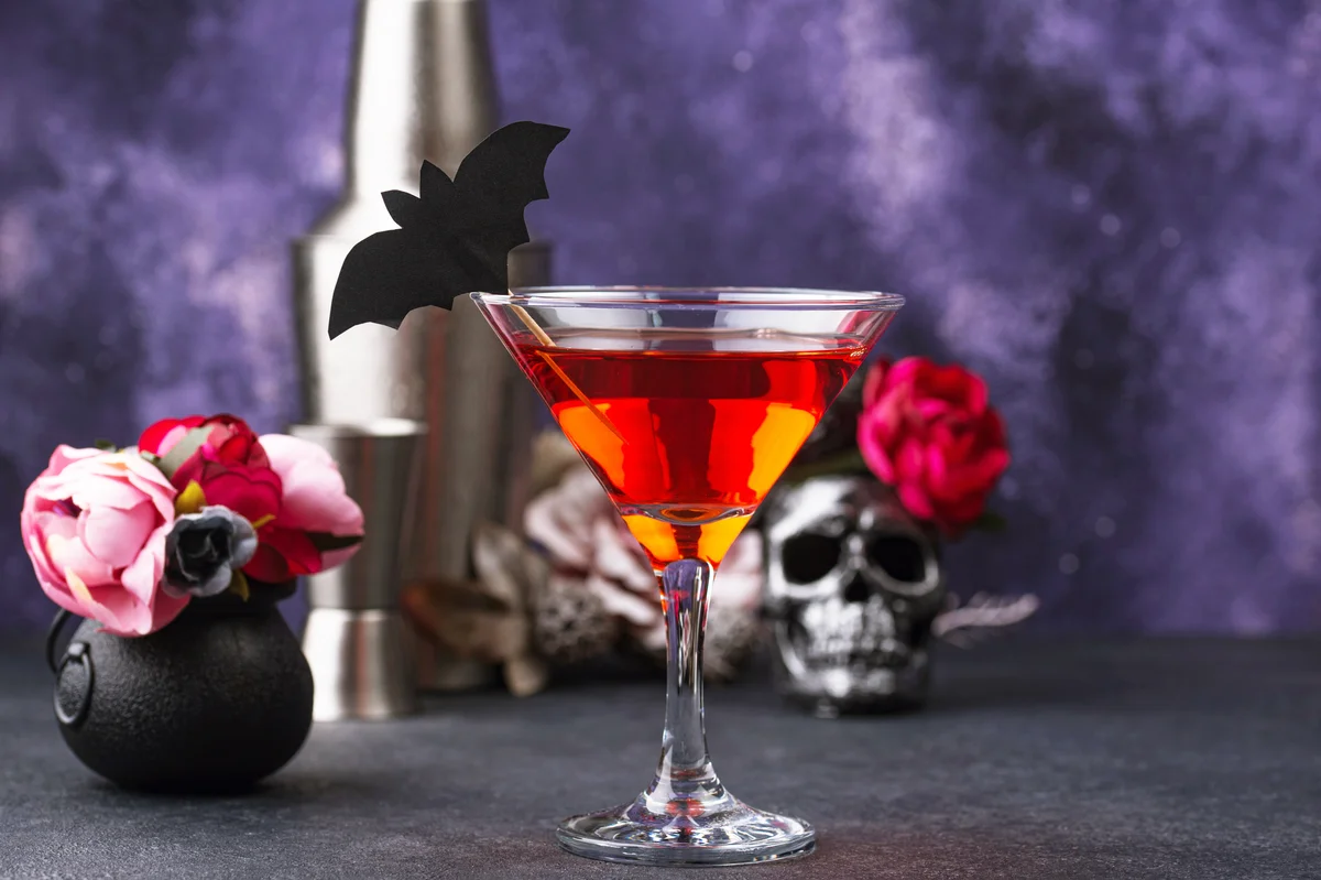 Halloween martini cocktail on purple background