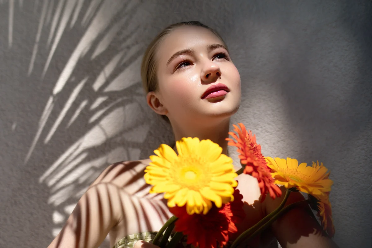 Woman with gerbera daisies in her hands