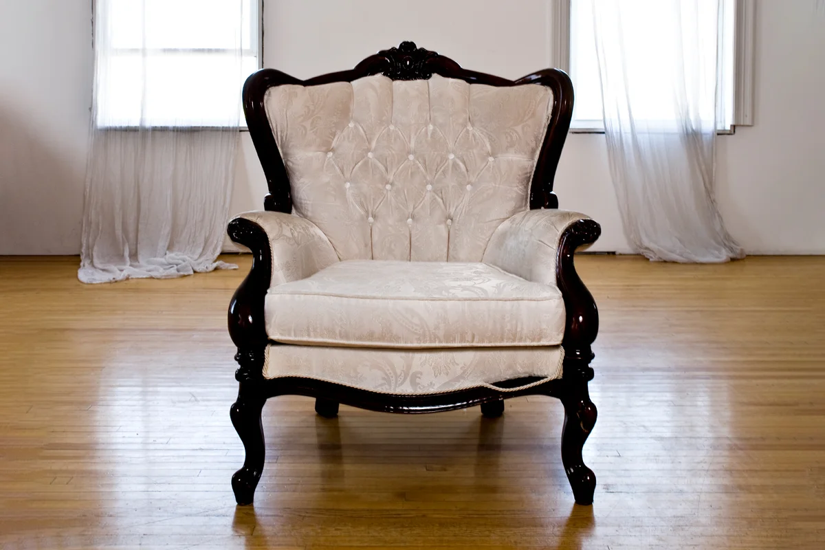 elegant Victorian chair in an empty room