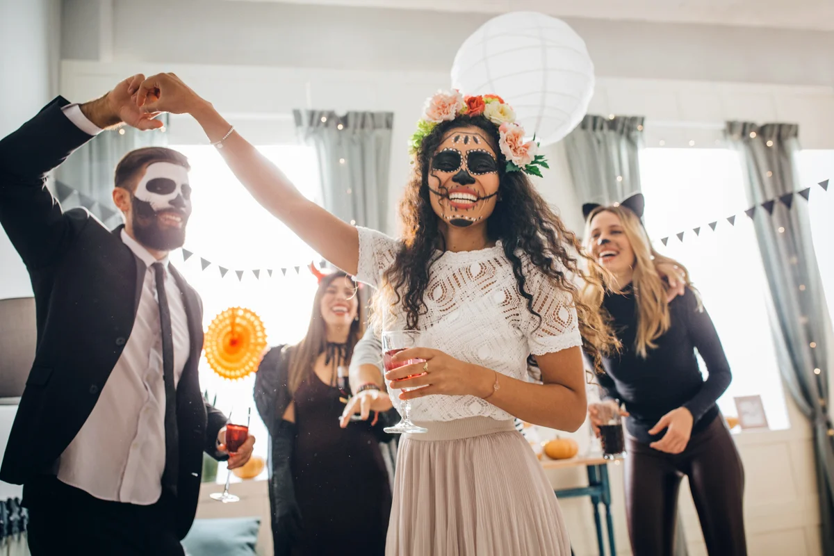 Group of Young people at home celebrating Halloween in costumes