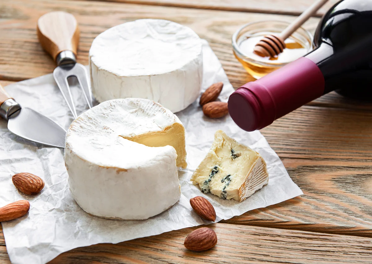 Various types of cheese, blue cheese, bree, camambert and wine