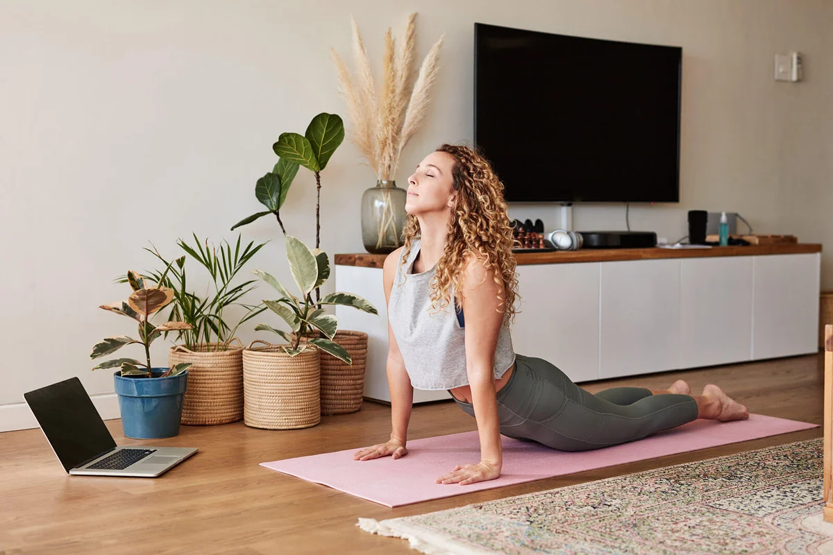 young woman practicing her yoga routine at home