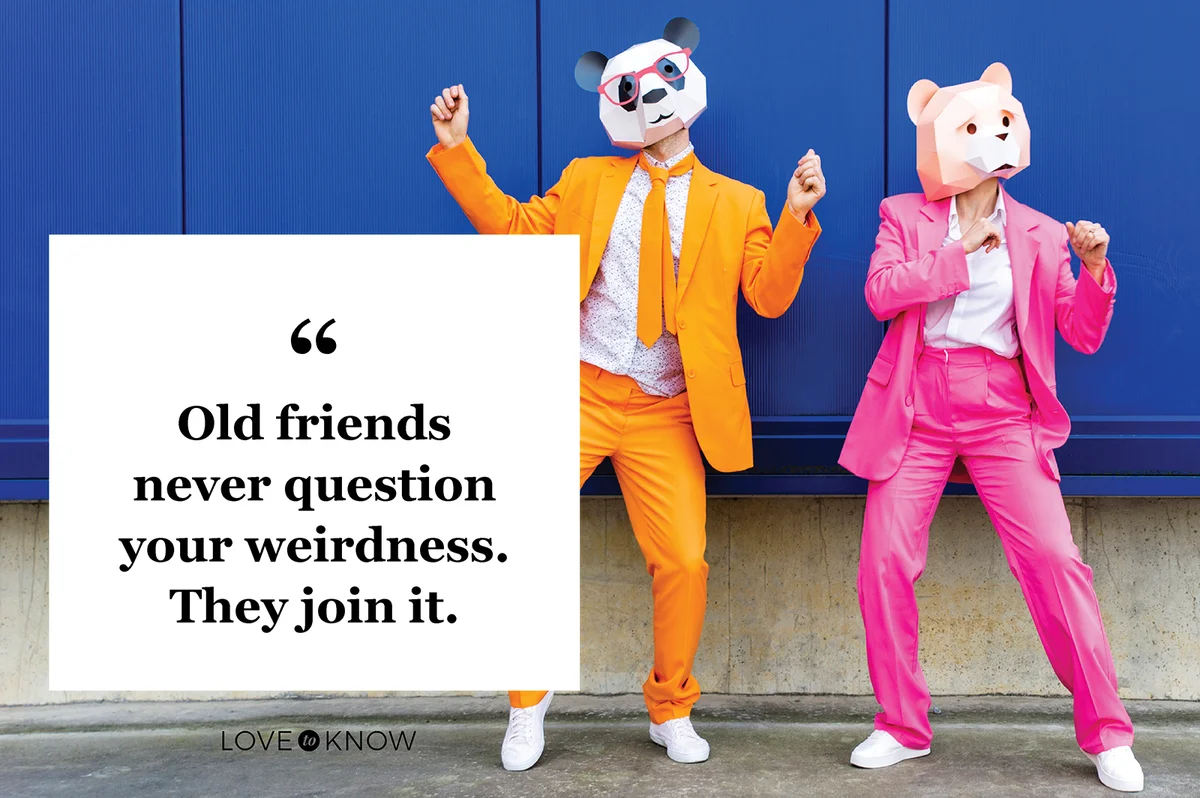 Man and woman wearing vibrant suits and bear masks dancing side by side