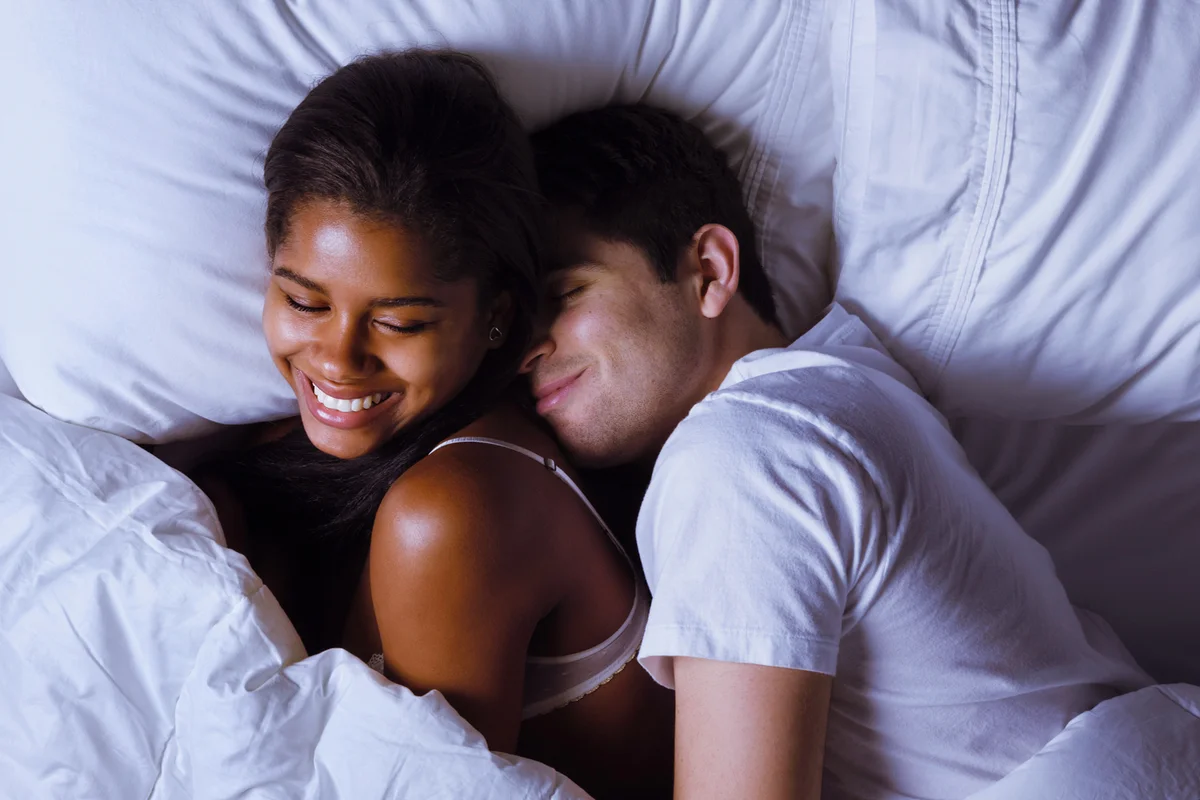 Happy Young Couple in Bed