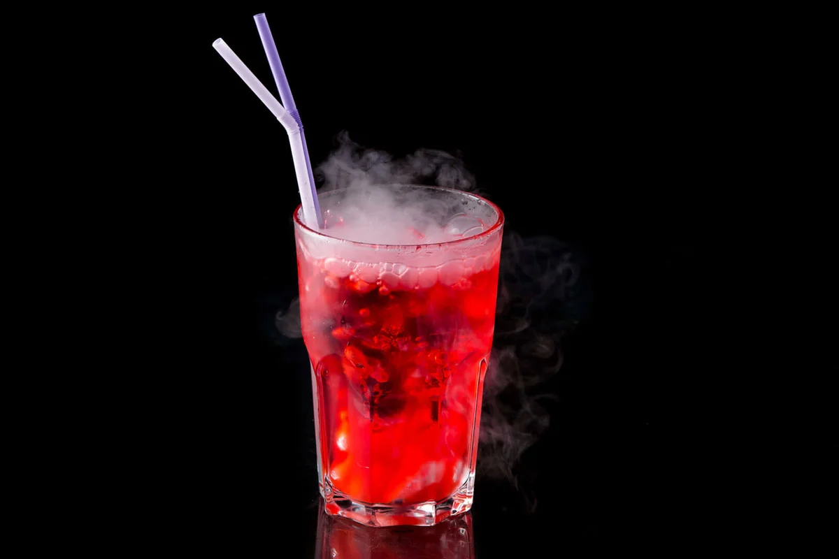 red alcohol cocktail with dry ice