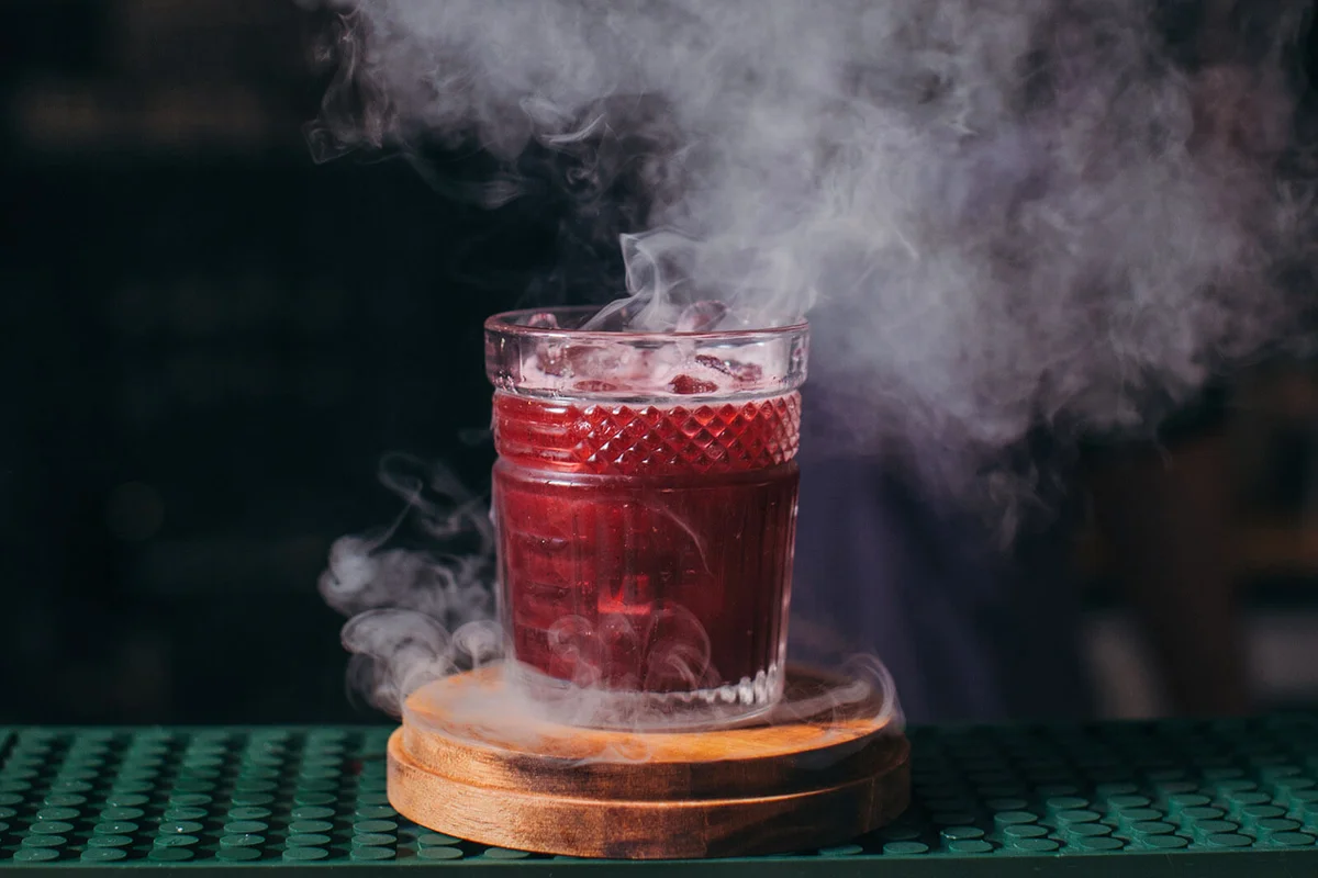 Barman preparing a smoky cocktail