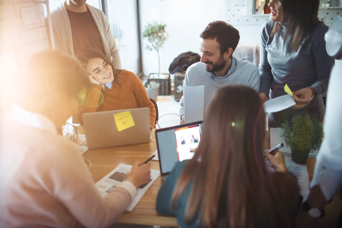 Group of coworkers having fun while working in their office