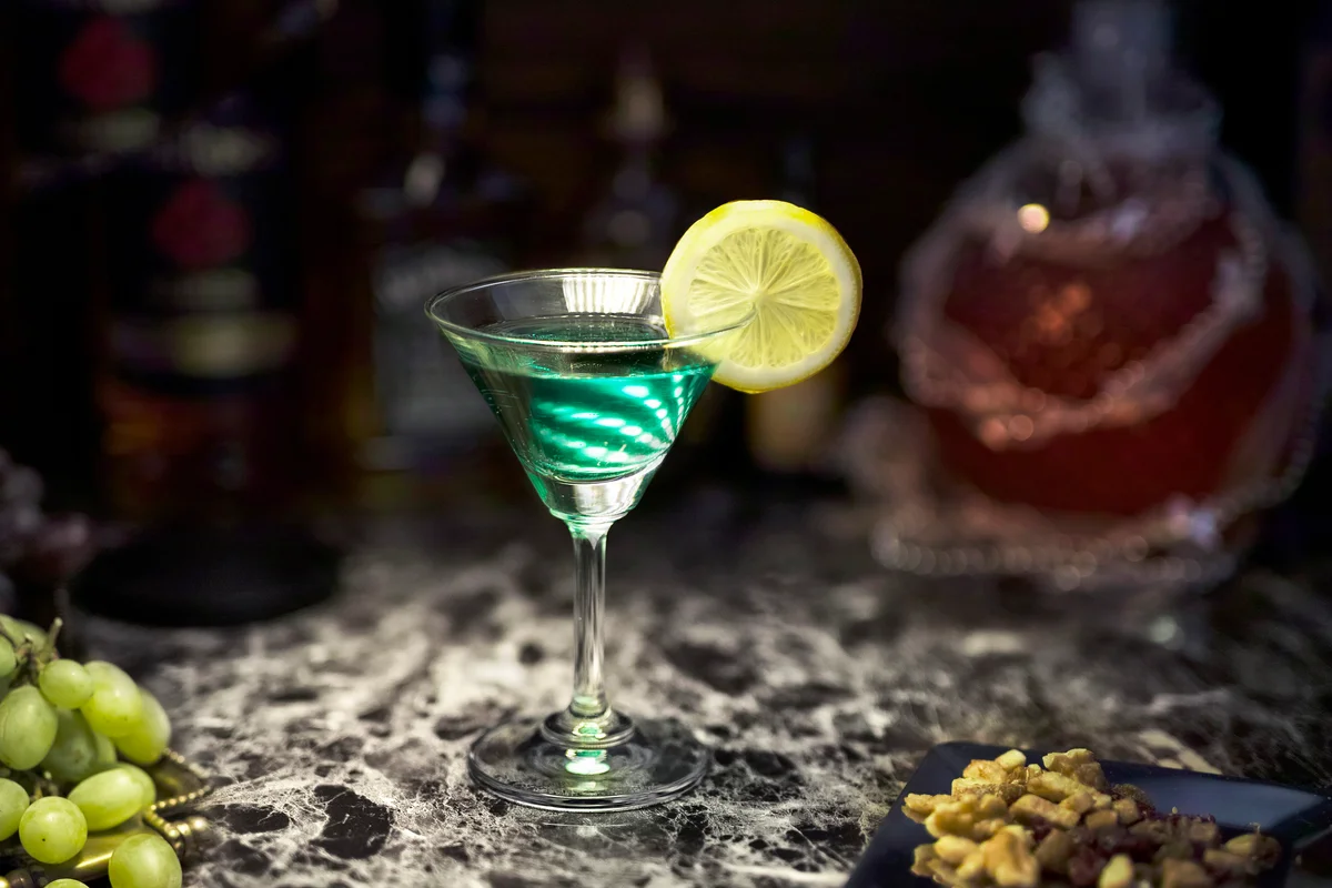 Green cocktail, nuts and grapes