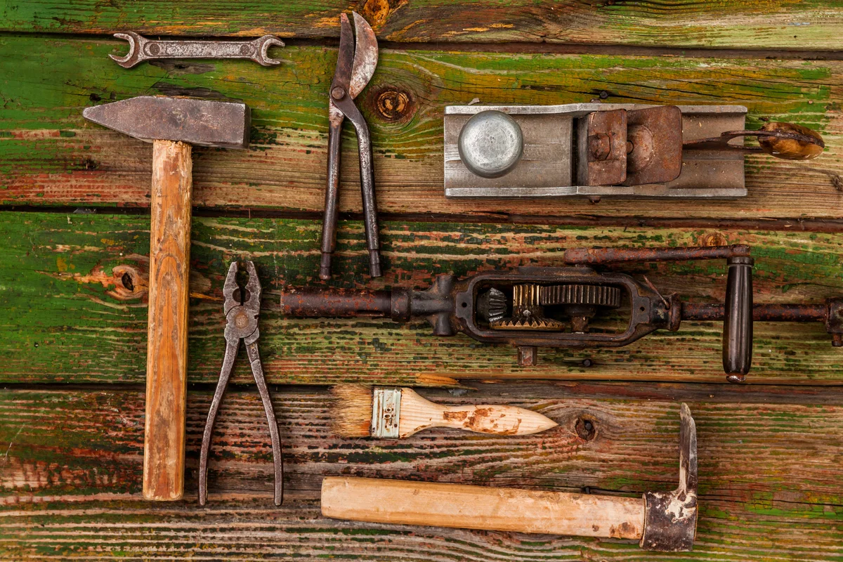 antique tools on weathered wooden table
