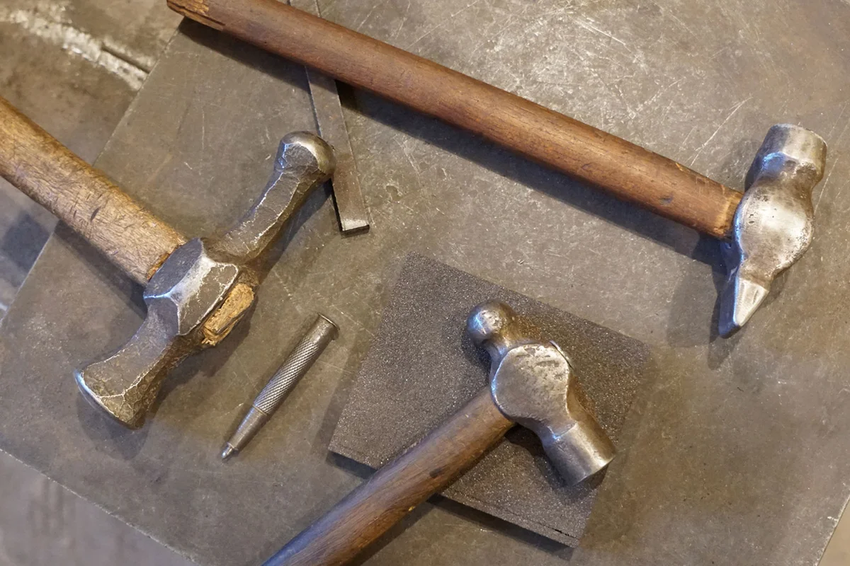 three antique blacksmith hammers