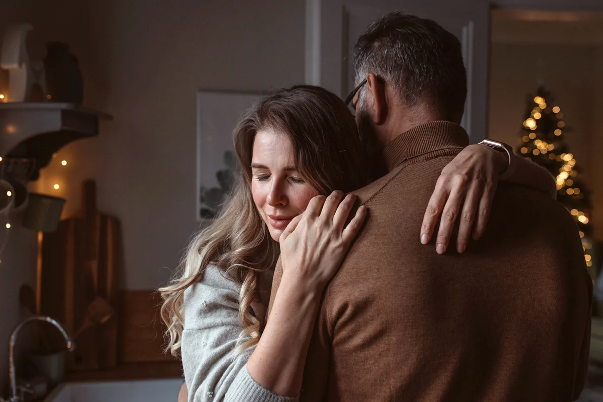 Sad couple hugging at Christmas