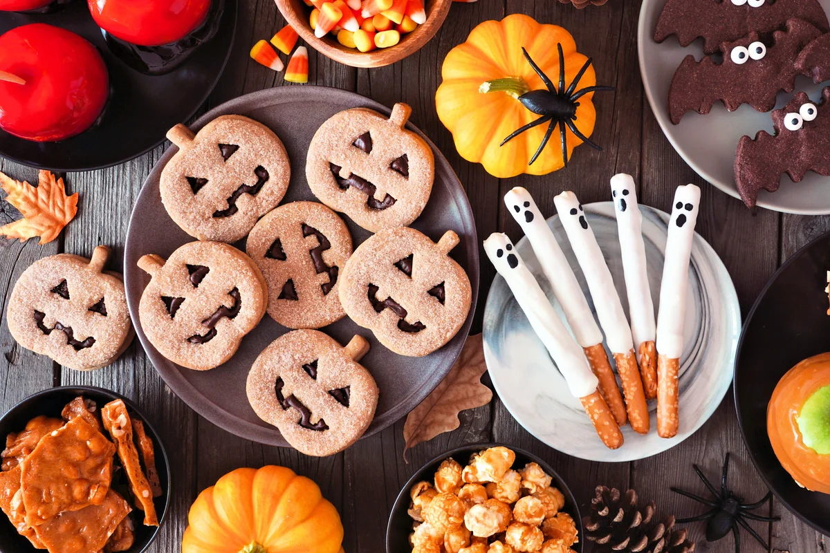 Halloween treat table scene with pumpkin cookies