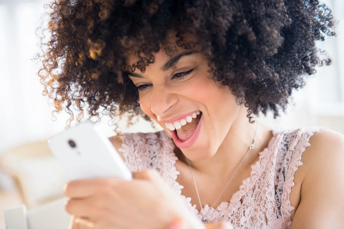 Smiling woman using cell phone
