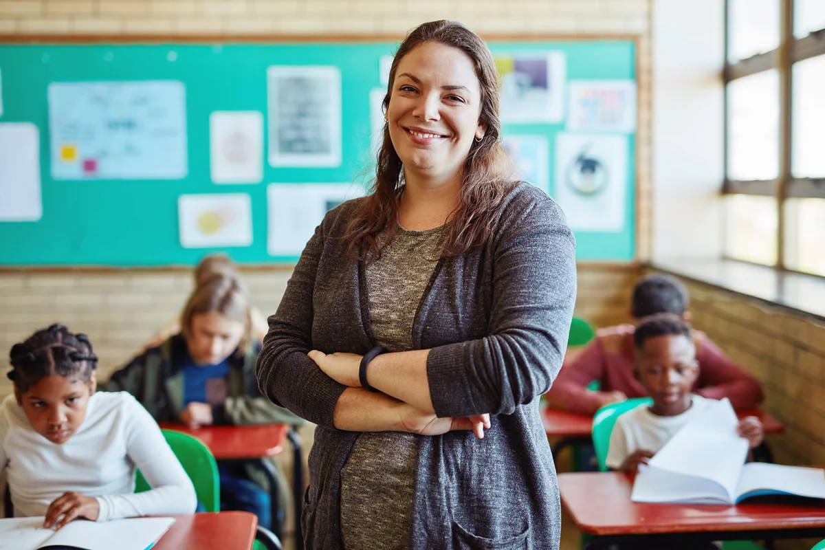 Shot of a confident young woman teaching a class of young children at school