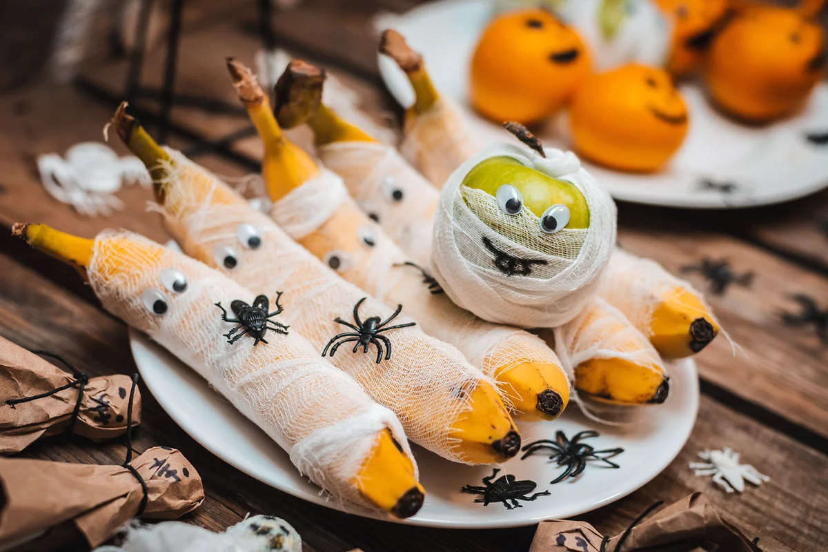Mummified fruit cheesecloth wrapped apple and banana with googly eyes