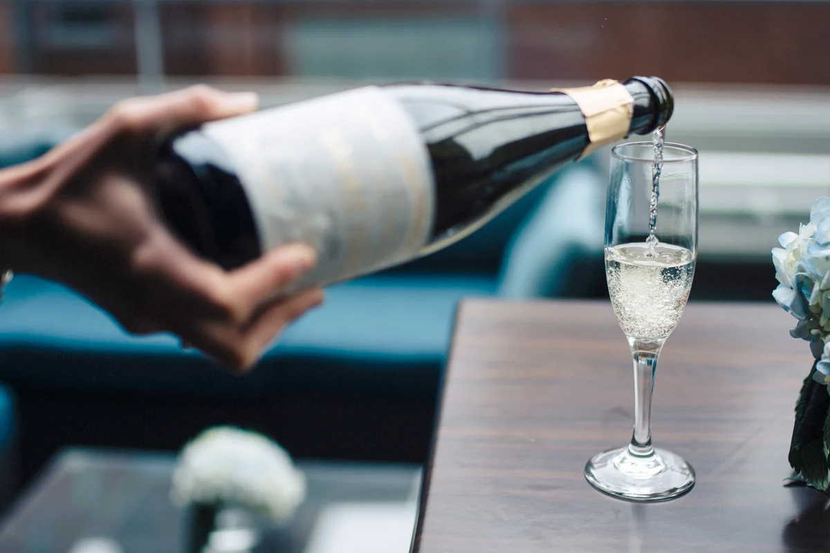 Person serving sparkling wine