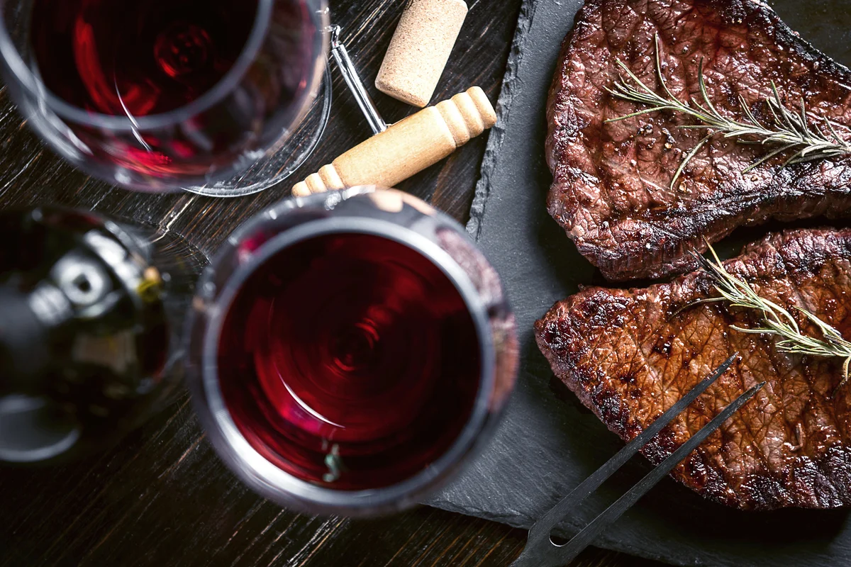 Dinner for two with ribeye steaks and red wine