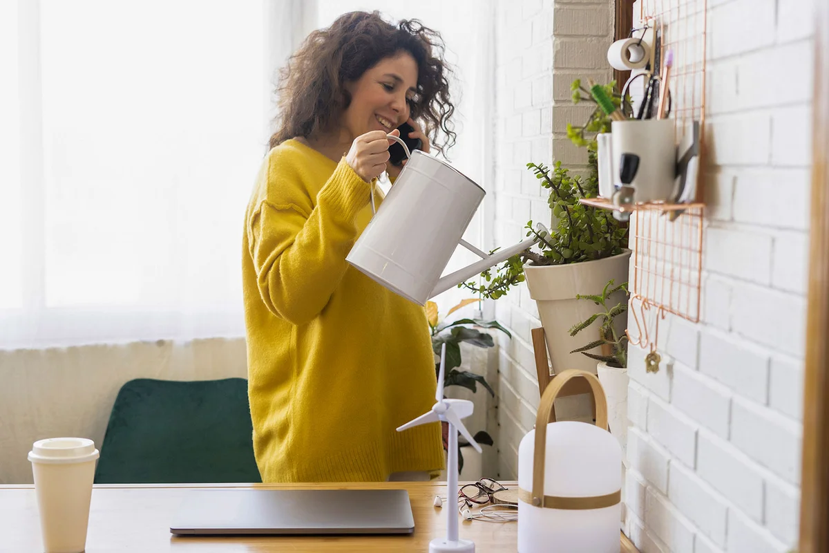 woman watering plant as a hobby for self care