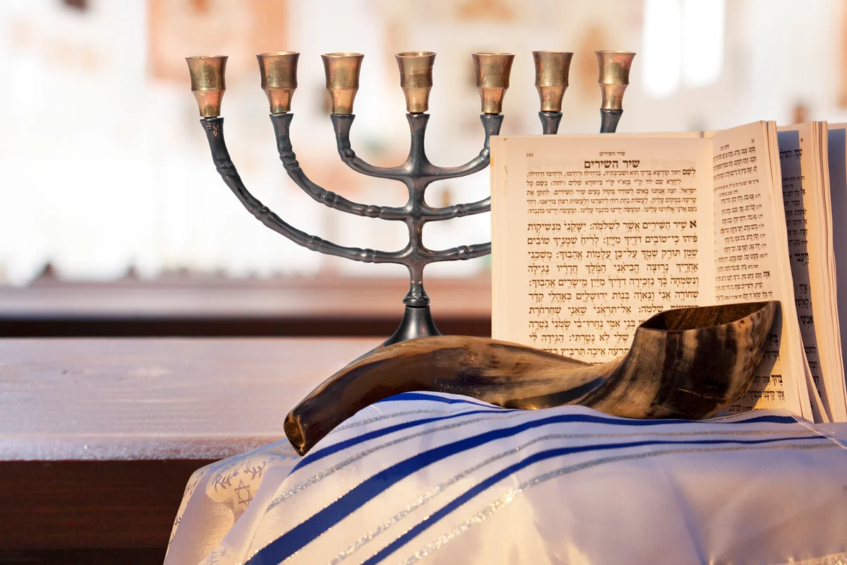Menorah, Shofar, prayer book and prayer shawl for the high holiday of Rosh Hashanah