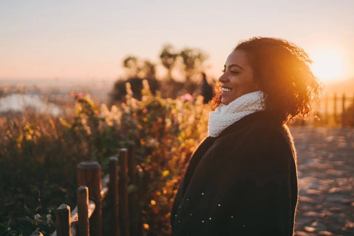 woman on hill at sunset
