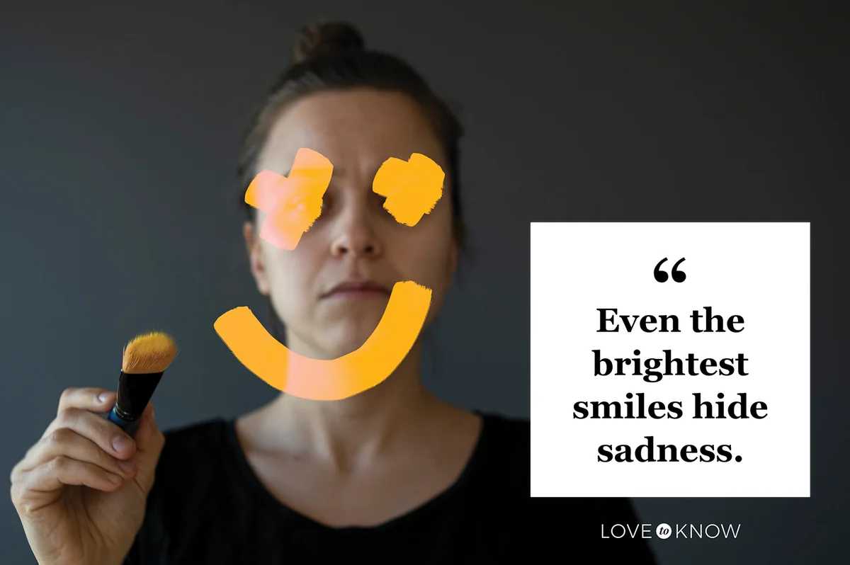Unhappy woman is drawing a smile on her face in the mirror