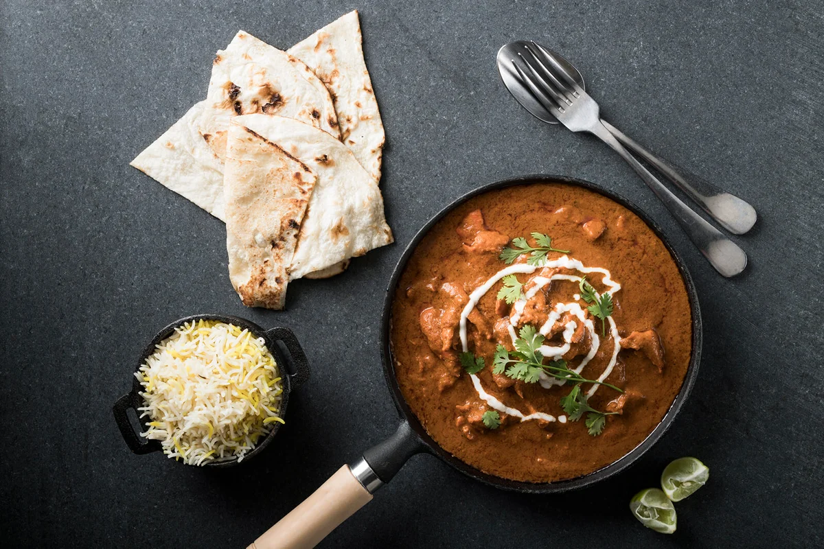 Chicken Tikka Masala, served with naan bread and rice