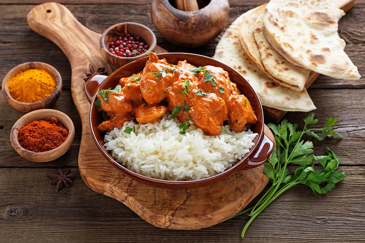 Chicken tikka masala spicy curry meat food in a clay plate with ric