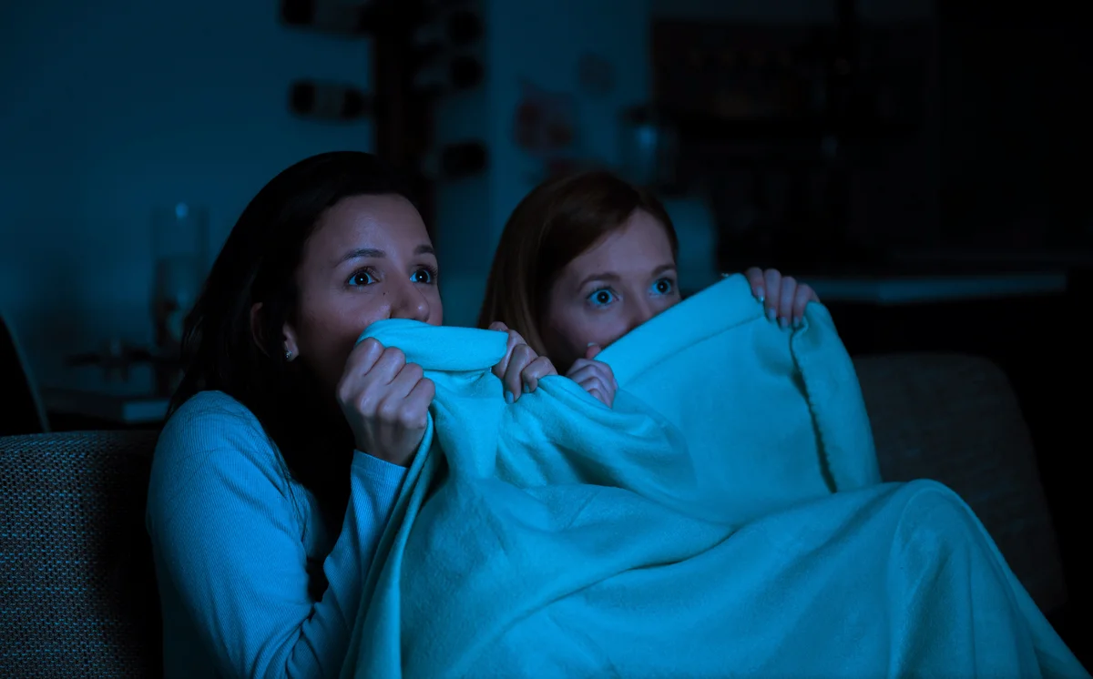 Two women watching an horror movie