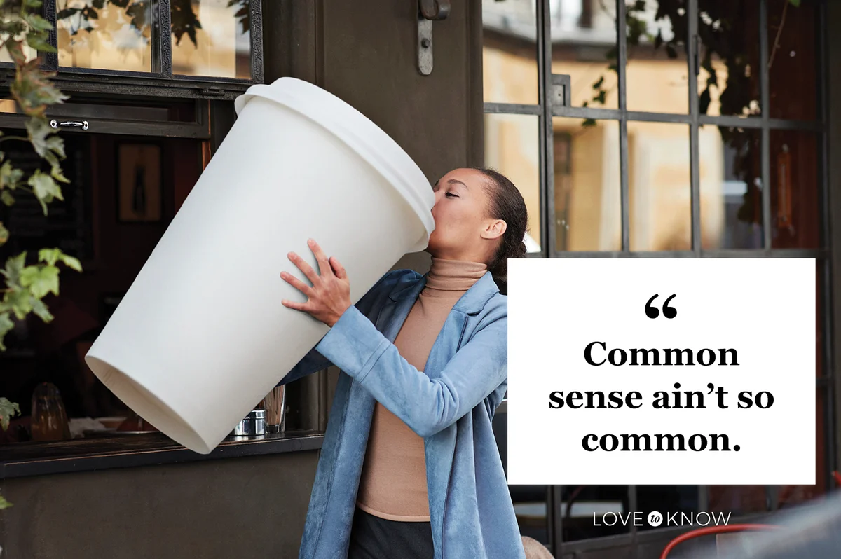 Woman drinking coffee from large disposable cup at take away counter of cafe