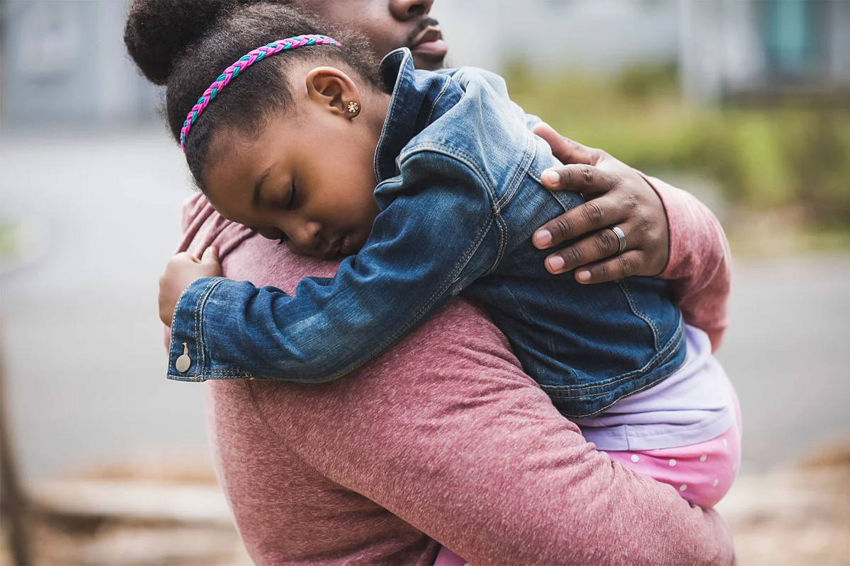 father hugging daughter